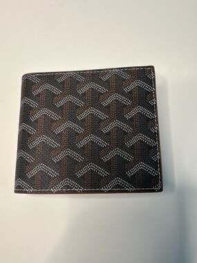 The black Goyard Victoire wallet is a sleek and...